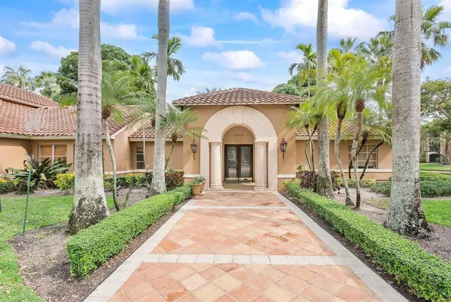 a front view of a house with a garden and pathway