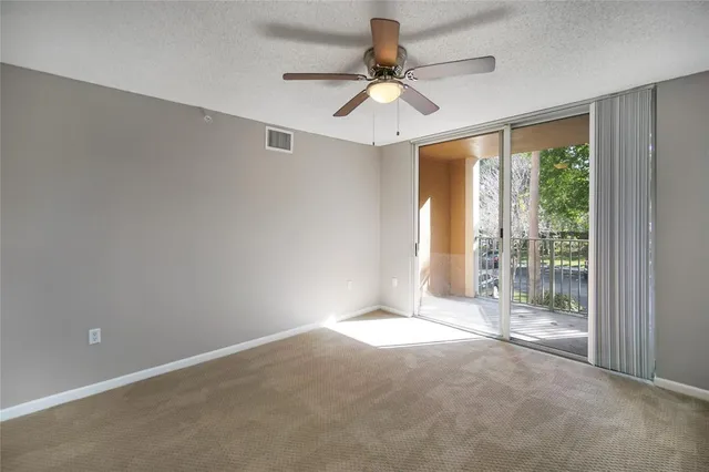 a view of a livingroom with a ceiling fan and window