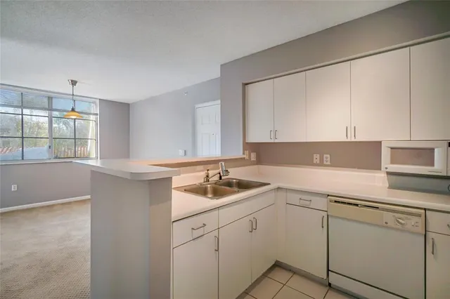 a kitchen with a sink cabinets and window