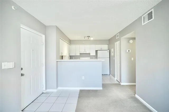 a view of a kitchen with white cabinets