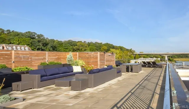 a view of a lake with couches chairs