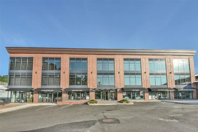 a front view of a building with a street view