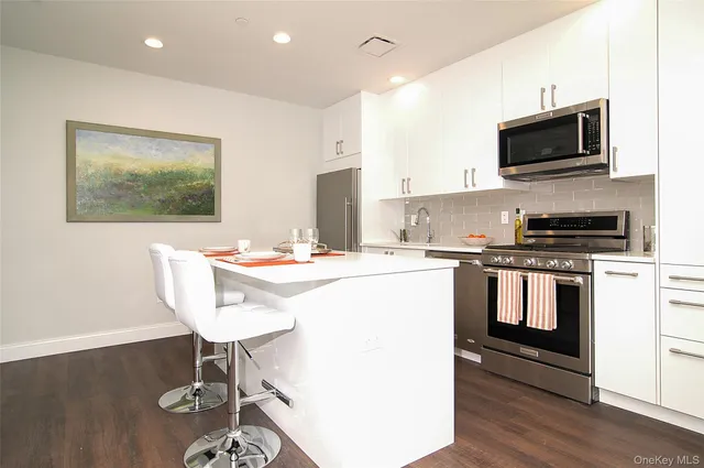 a kitchen with a sink cabinets and wooden floor