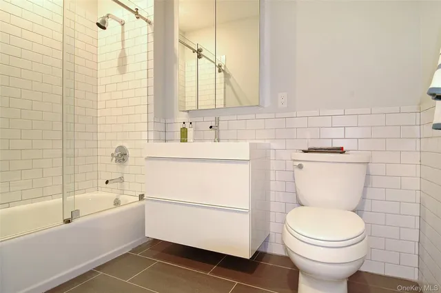 a bathroom with a toilet and a bathtub