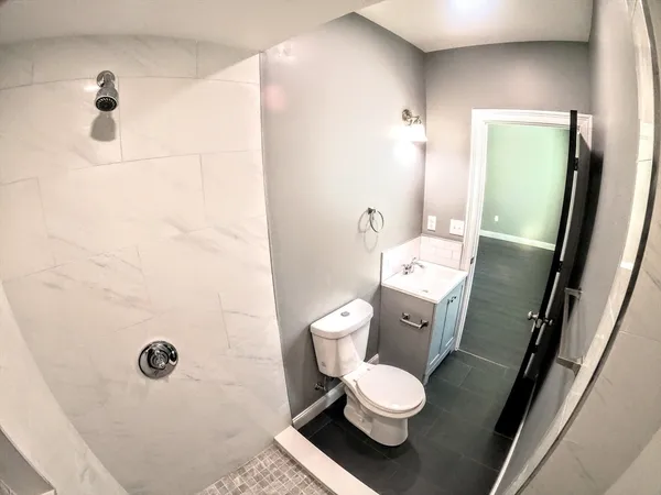 a bathroom with a toilet sink and shower