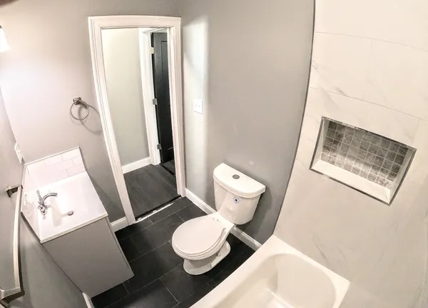 a white toilet sitting next to a bathroom sink