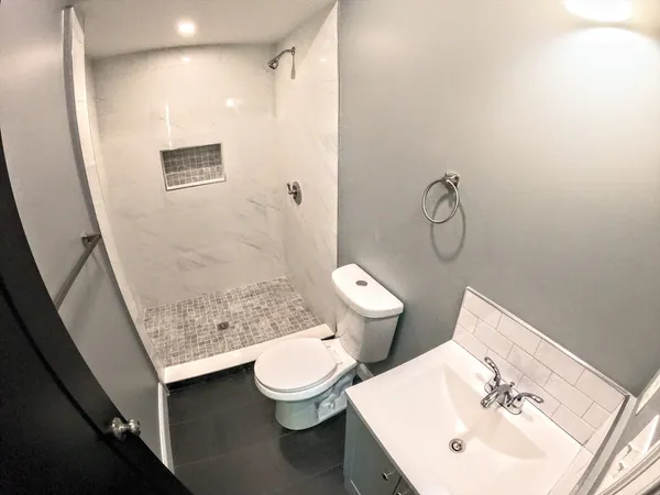 a bathroom with a sink toilet and shower