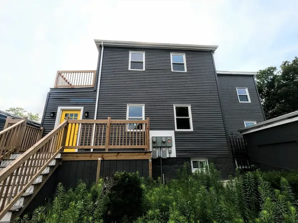 a view of a house with wooden fence