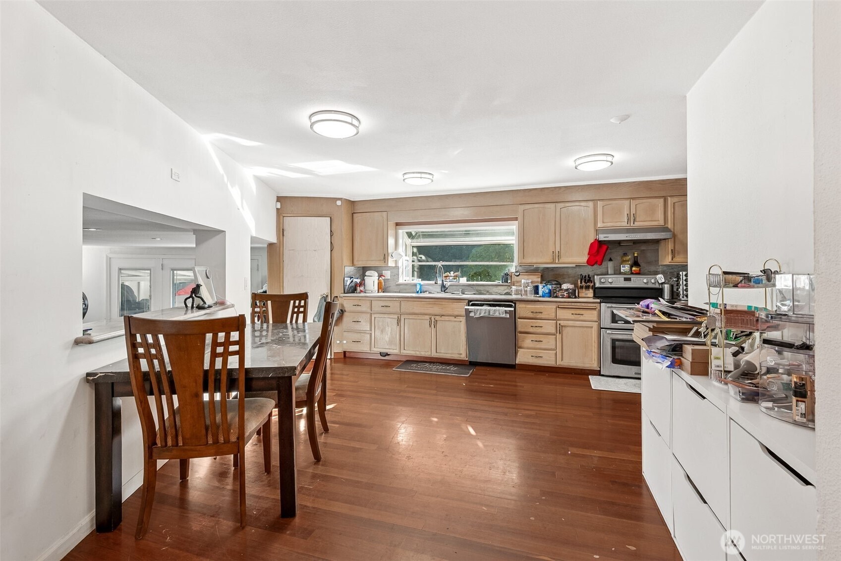 13718 Macadam Road South Tukwila, WA 98168 - Photo 4 of 12 a kitchen with stainless steel appliances a table and chairs in it