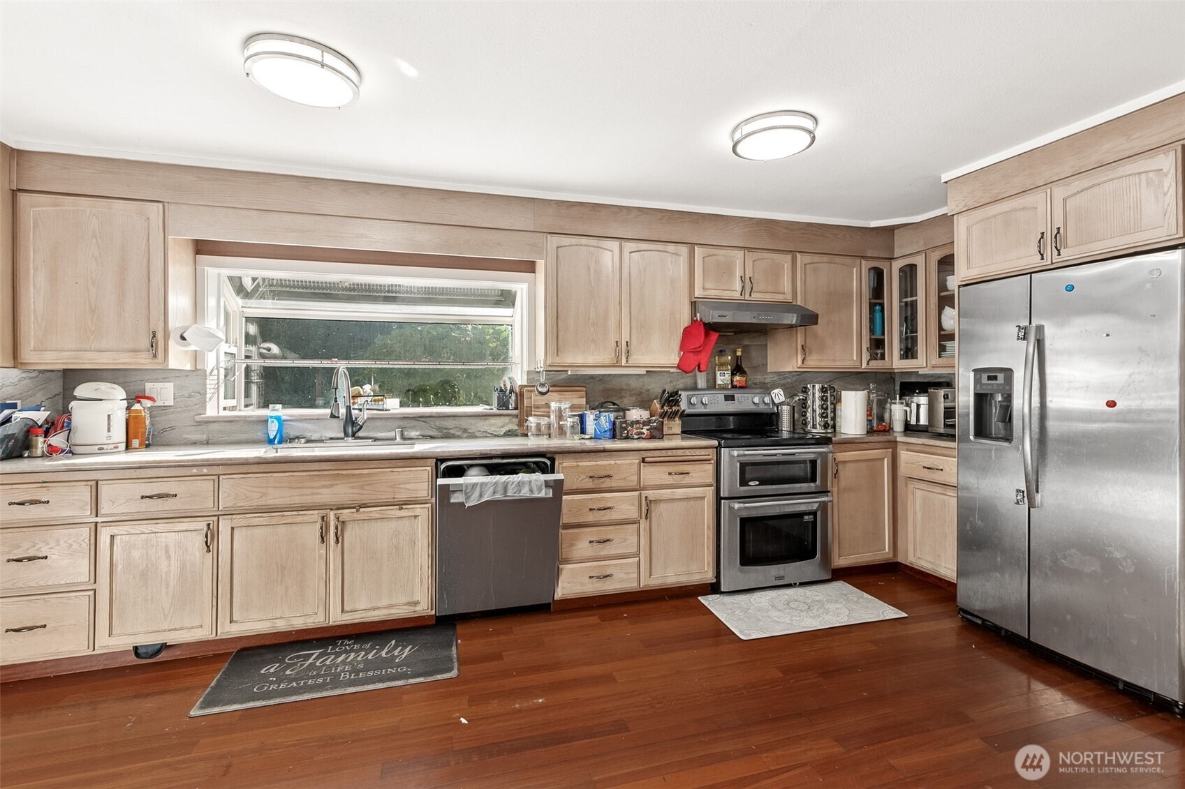 13718 Macadam Road South Tukwila, WA 98168 - Photo 5 of 12 a kitchen with granite countertop stainless steel appliances a sink cabinets and a window