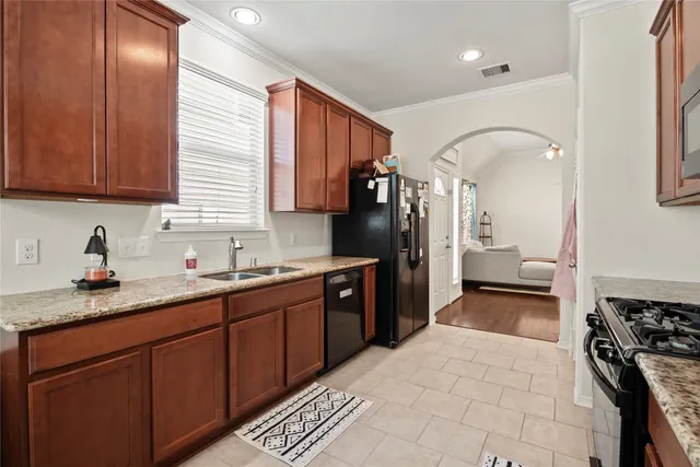 a kitchen with a sink stove and refrigerator