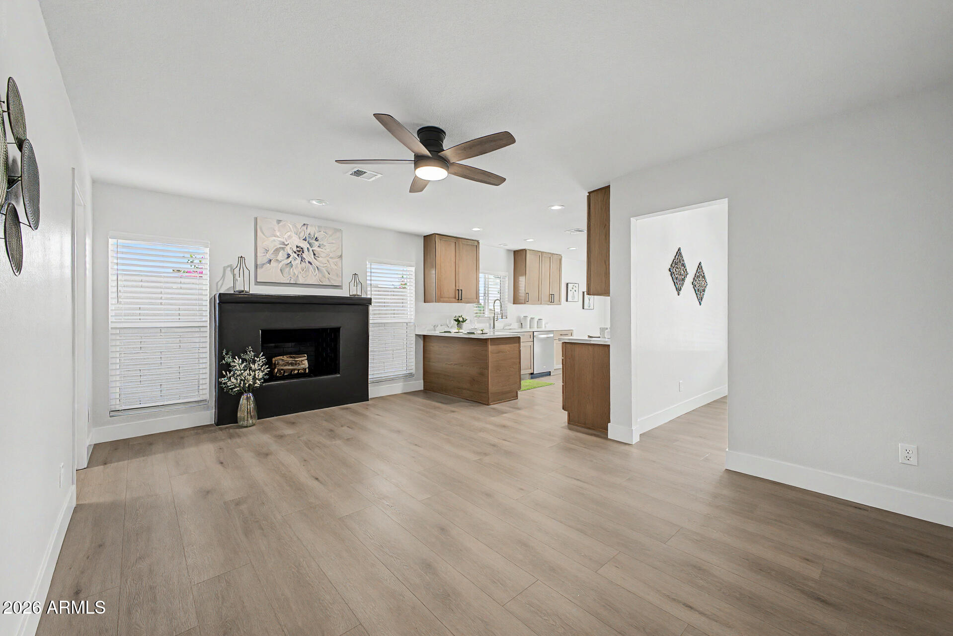 1009 West Pampa Avenue Mesa, AZ 85210 - Photo 10 of 31 a view of a livingroom with a fireplace and a ceiling fan