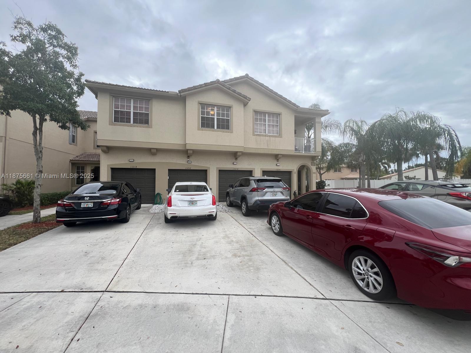13218 Southwest 44th Street, Unit 11106 Miramar, FL 33027 - Photo 1 of 23 a car parked in front of a house