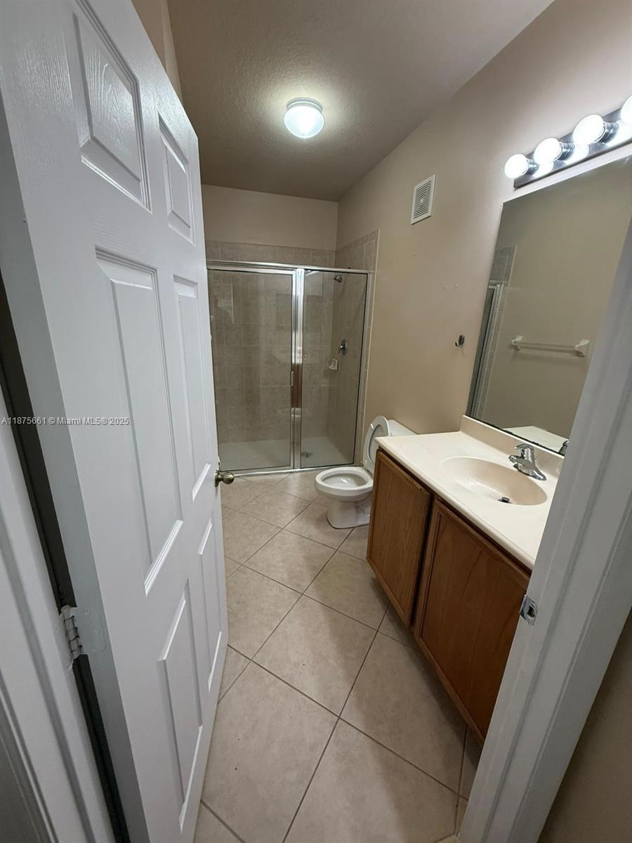13218 Southwest 44th Street, Unit 11106 Miramar, FL 33027 - Photo 11 of 23 a bathroom with a sink a toilet and shower