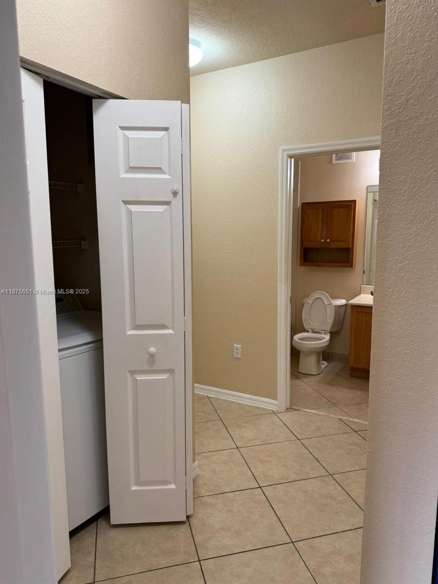 13218 Southwest 44th Street, Unit 11106 Miramar, FL 33027 - Photo 12 of 23 a living room with furniture and a flat screen tv