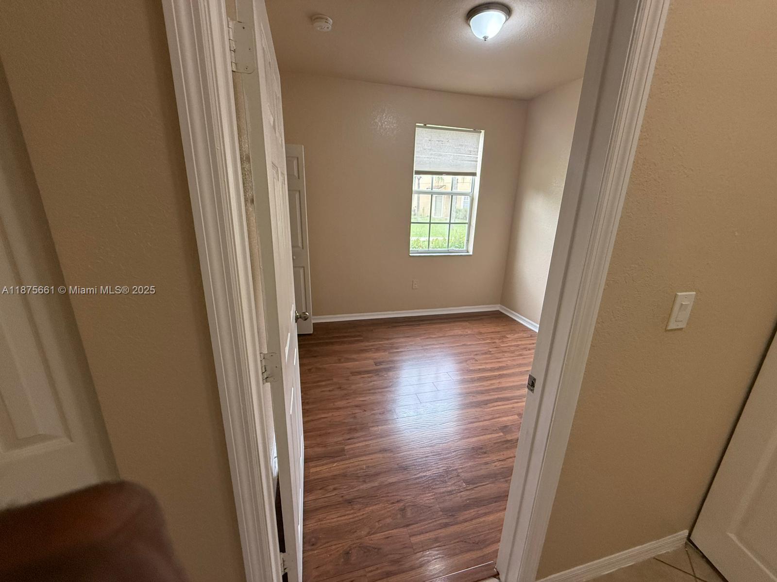 13218 Southwest 44th Street, Unit 11106 Miramar, FL 33027 - Photo 14 of 23 an empty room with wooden floor and windows