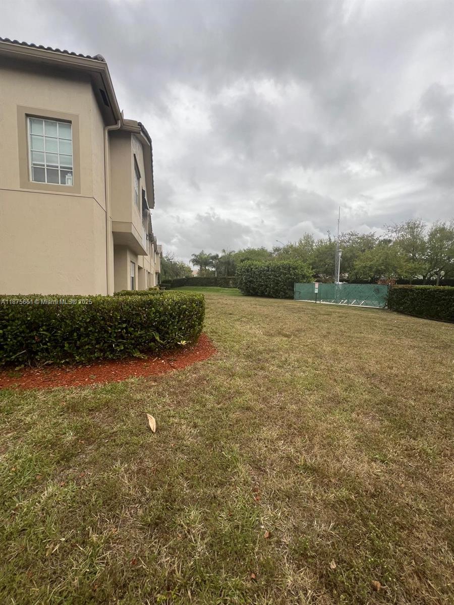 13218 Southwest 44th Street, Unit 11106 Miramar, FL 33027 - Photo 21 of 23 a front view of a house with a yard