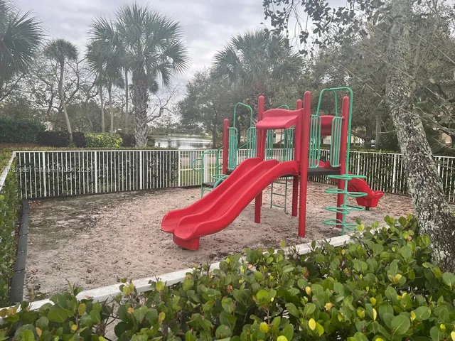 a view of a park with iron fence