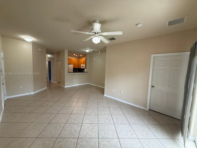 a view of a livingroom with a ceiling fan and window