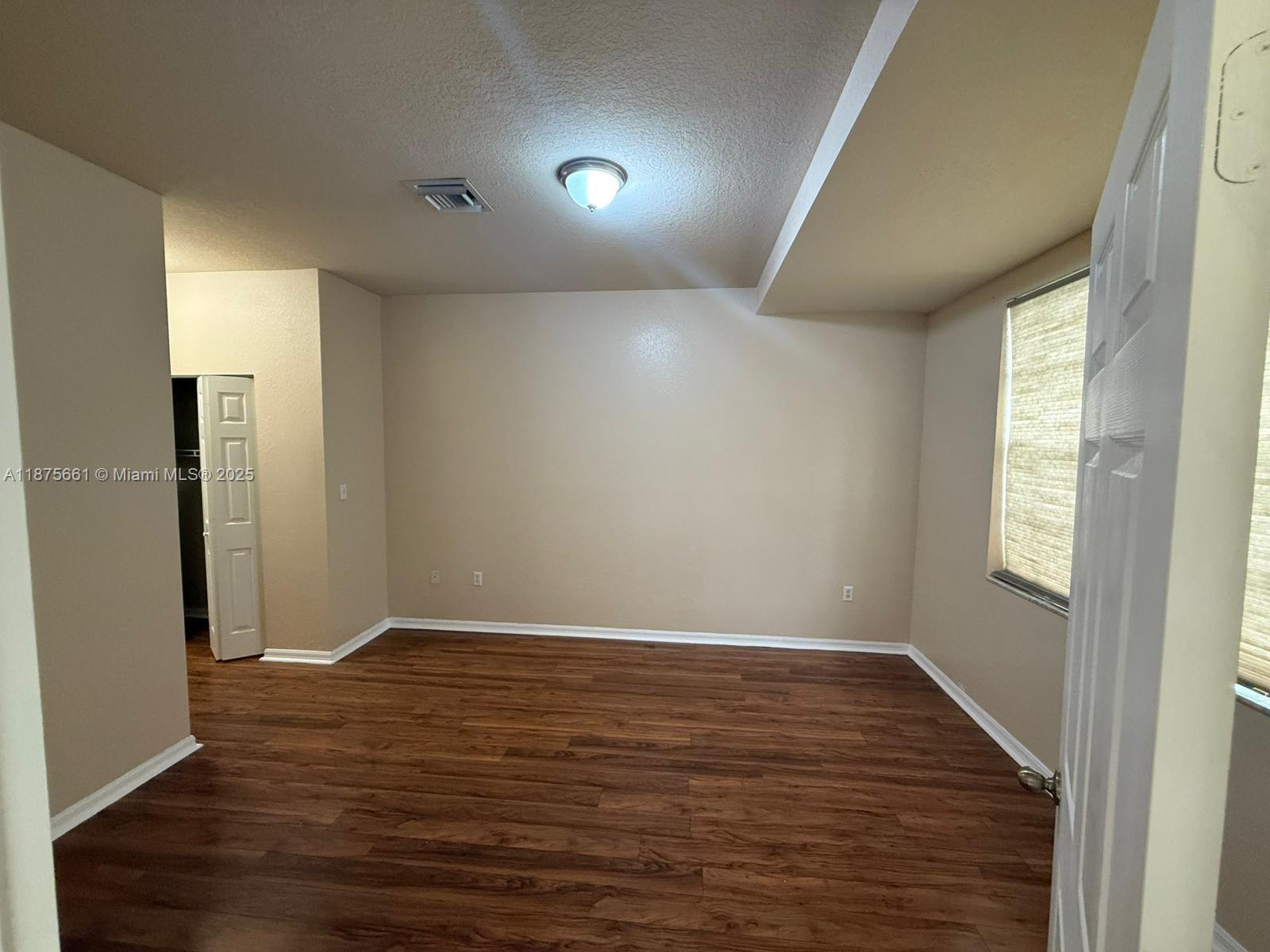 13218 Southwest 44th Street, Unit 11106 Miramar, FL 33027 - Photo 4 of 23 a view of room with window and wooden floor