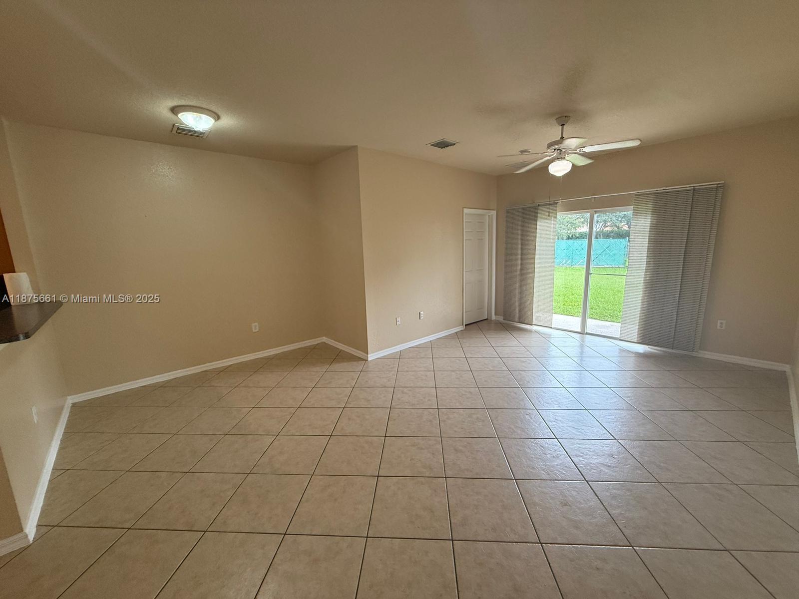 13218 Southwest 44th Street, Unit 11106 Miramar, FL 33027 - Photo 5 of 23 a view of an empty room with a window