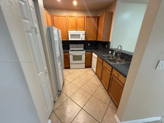 a kitchen with stainless steel appliances a refrigerator and a sink
