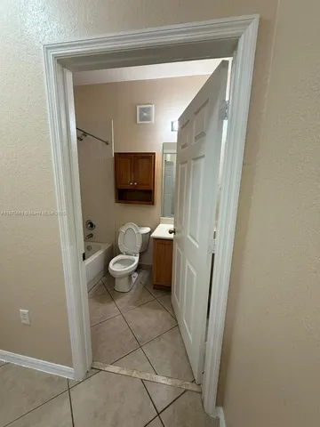 a bathroom with a toilet sink and a mirror