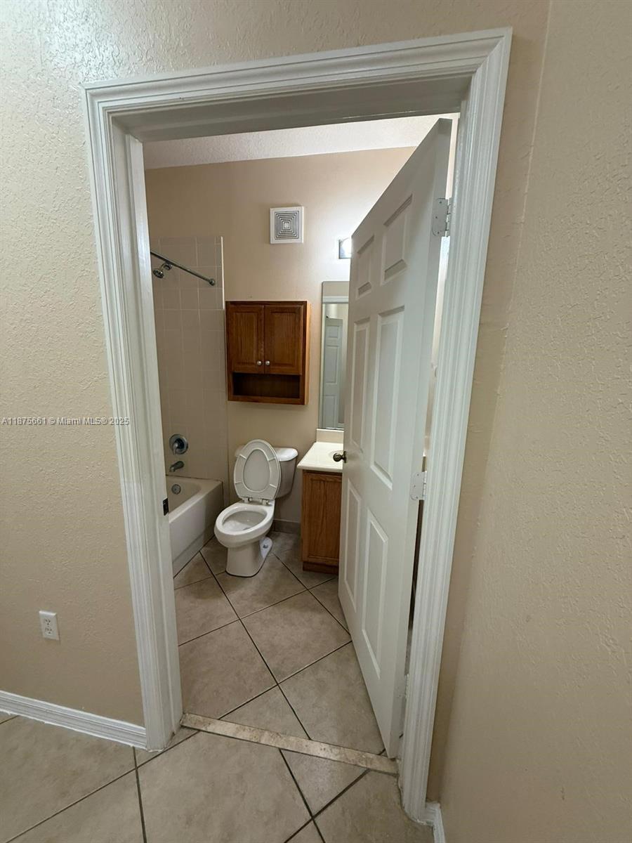 13218 Southwest 44th Street, Unit 11106 Miramar, FL 33027 - Photo 10 of 23 a bathroom with a toilet sink and a mirror