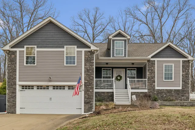 a front view of a house with a yard and garage