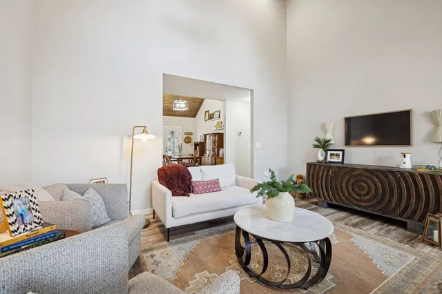 a view of a workspace with furniture and wooden floor