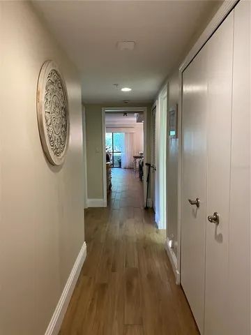 a view of a hallway with wooden floor