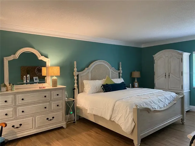 a bedroom with a bed and a dresser