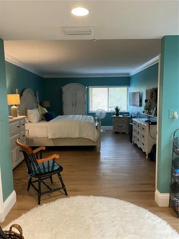 a bedroom with furniture and a wooden floor