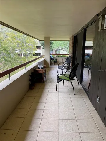 a dining room with furniture and a large window