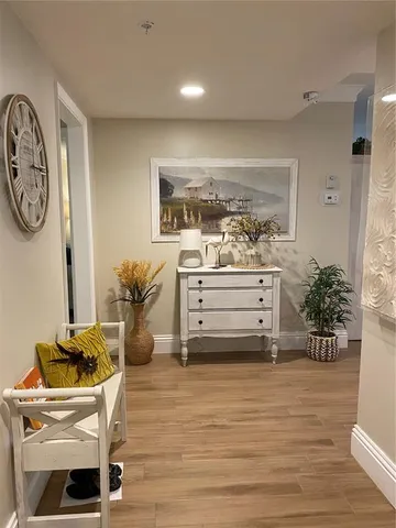a room with a lounge chair and potted plant