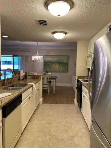 a kitchen with stainless steel appliances granite countertop a stove and a sink