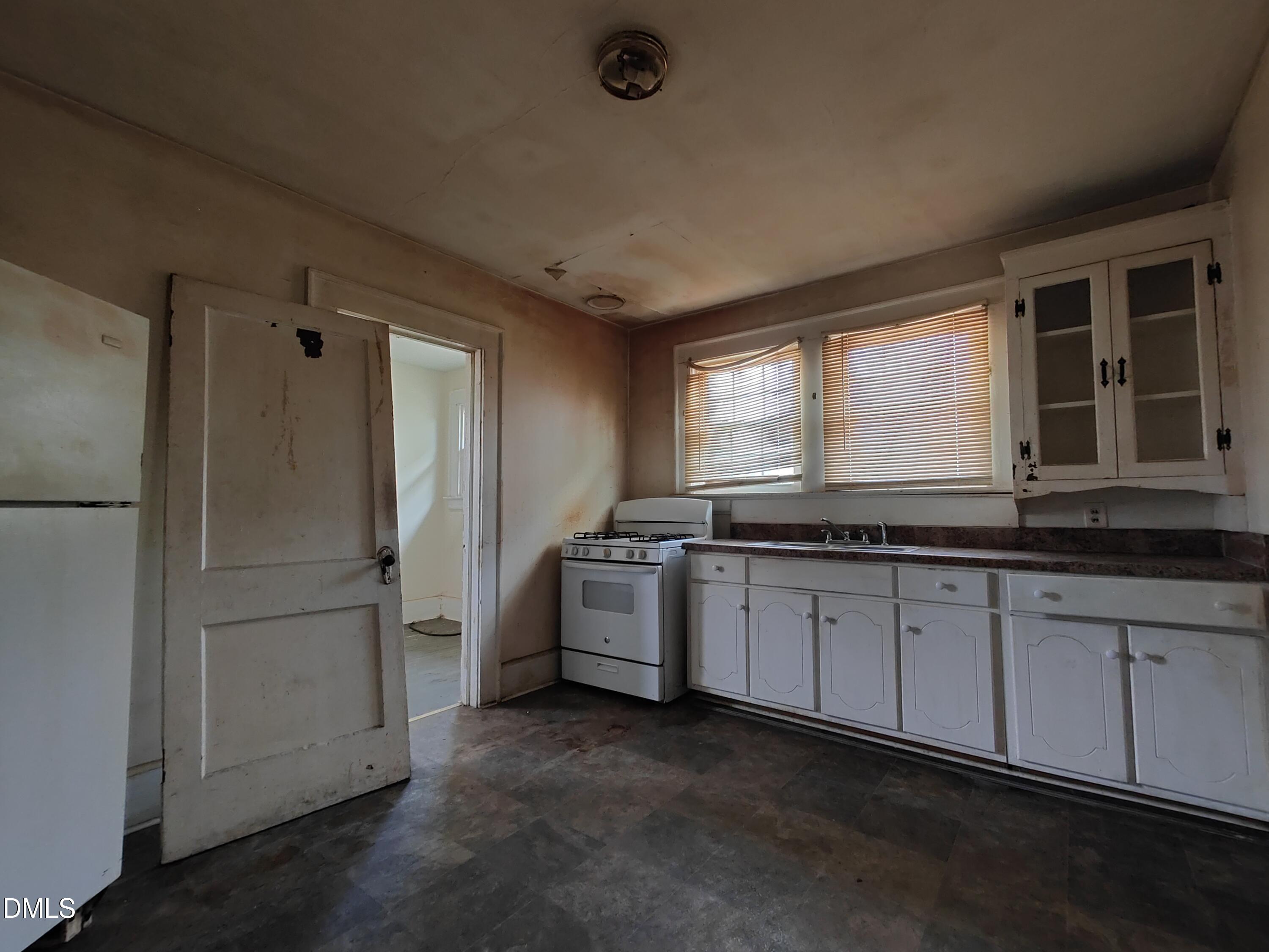 314-316 High Street Rocky Mount, NC 27803 - Photo 6 of 7 a kitchen with stainless steel appliances granite countertop a refrigerator and a sink