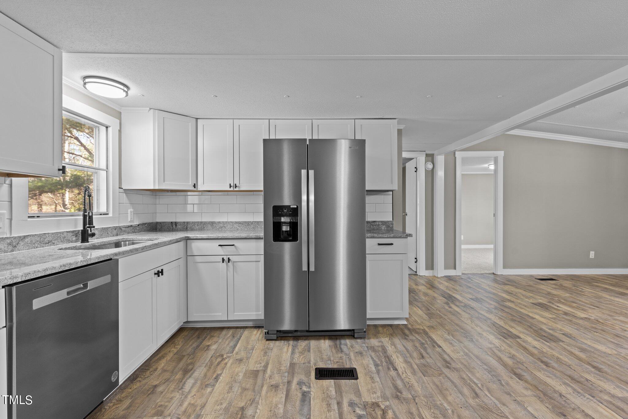 365 Rev Henderson Road Henderson, NC 27537 - Photo 13 of 48 a kitchen with a refrigerator sink and cabinets