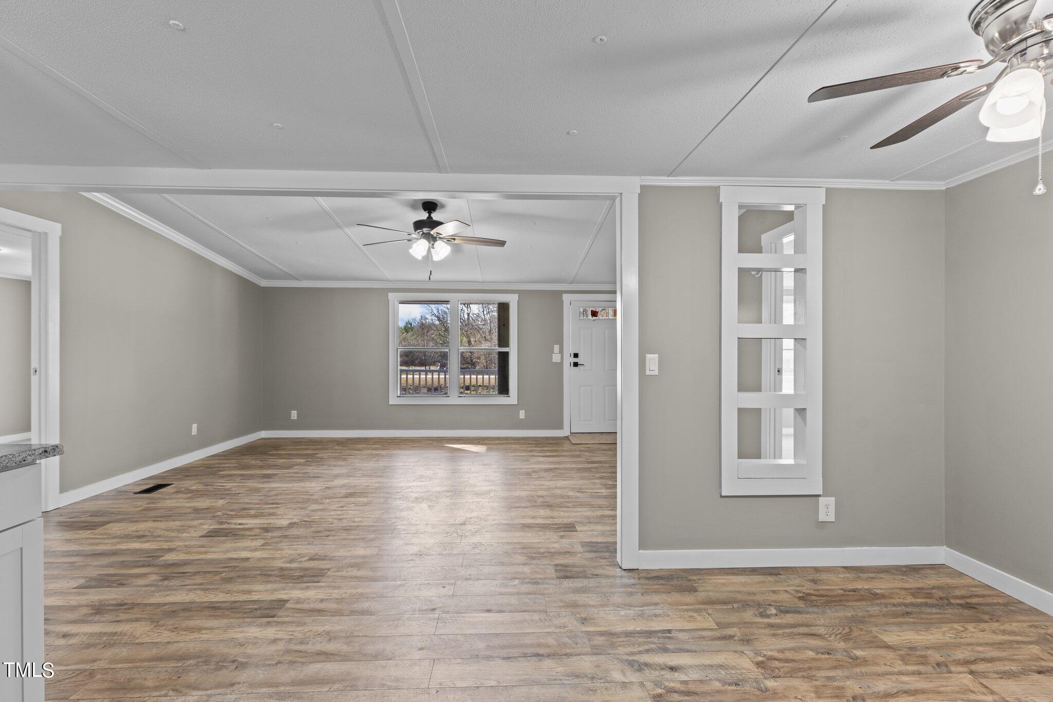 365 Rev Henderson Road Henderson, NC 27537 - Photo 15 of 48 a view of an empty room with window and wooden floor