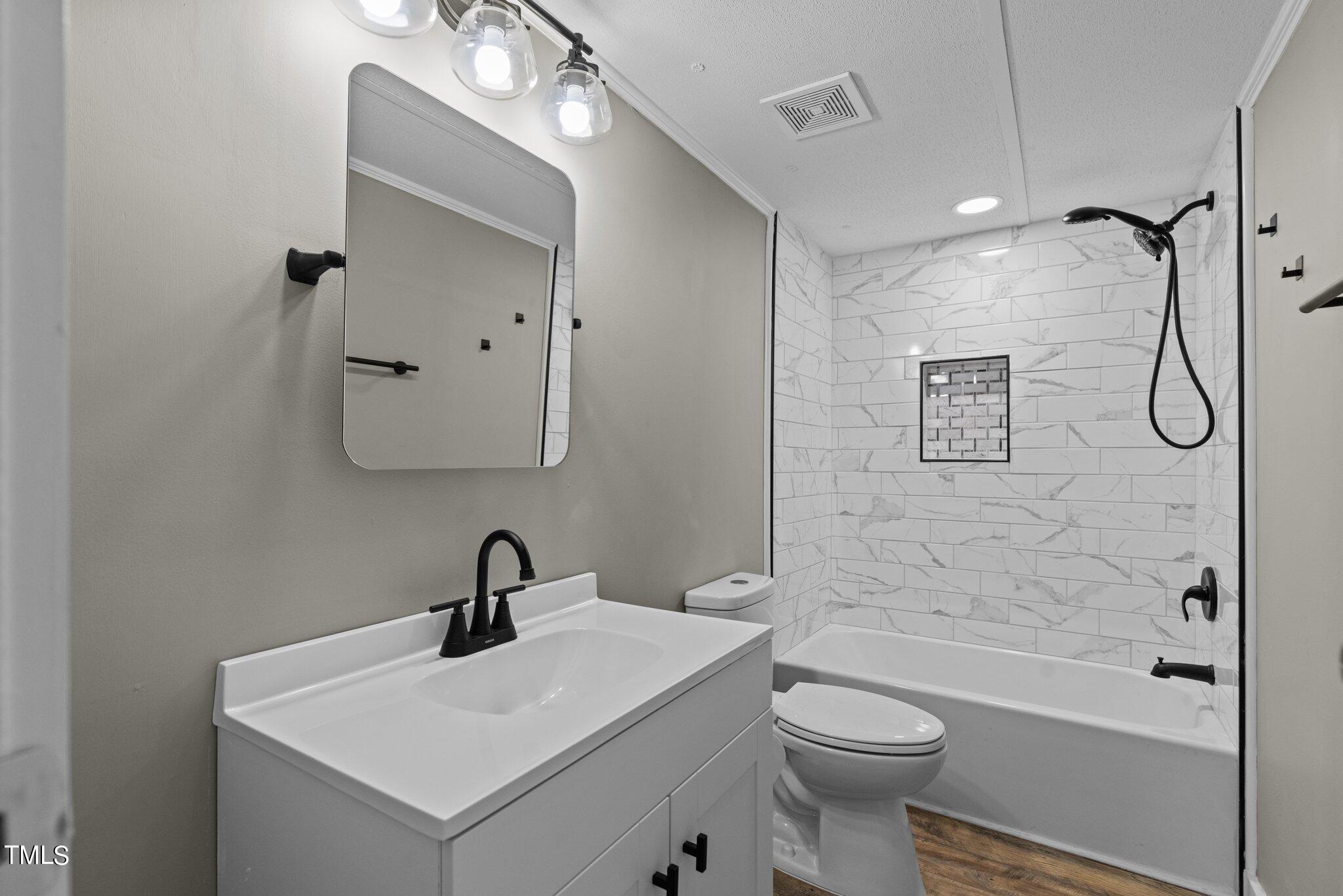 365 Rev Henderson Road Henderson, NC 27537 - Photo 21 of 48 a bathroom with a sink a toilet and shower