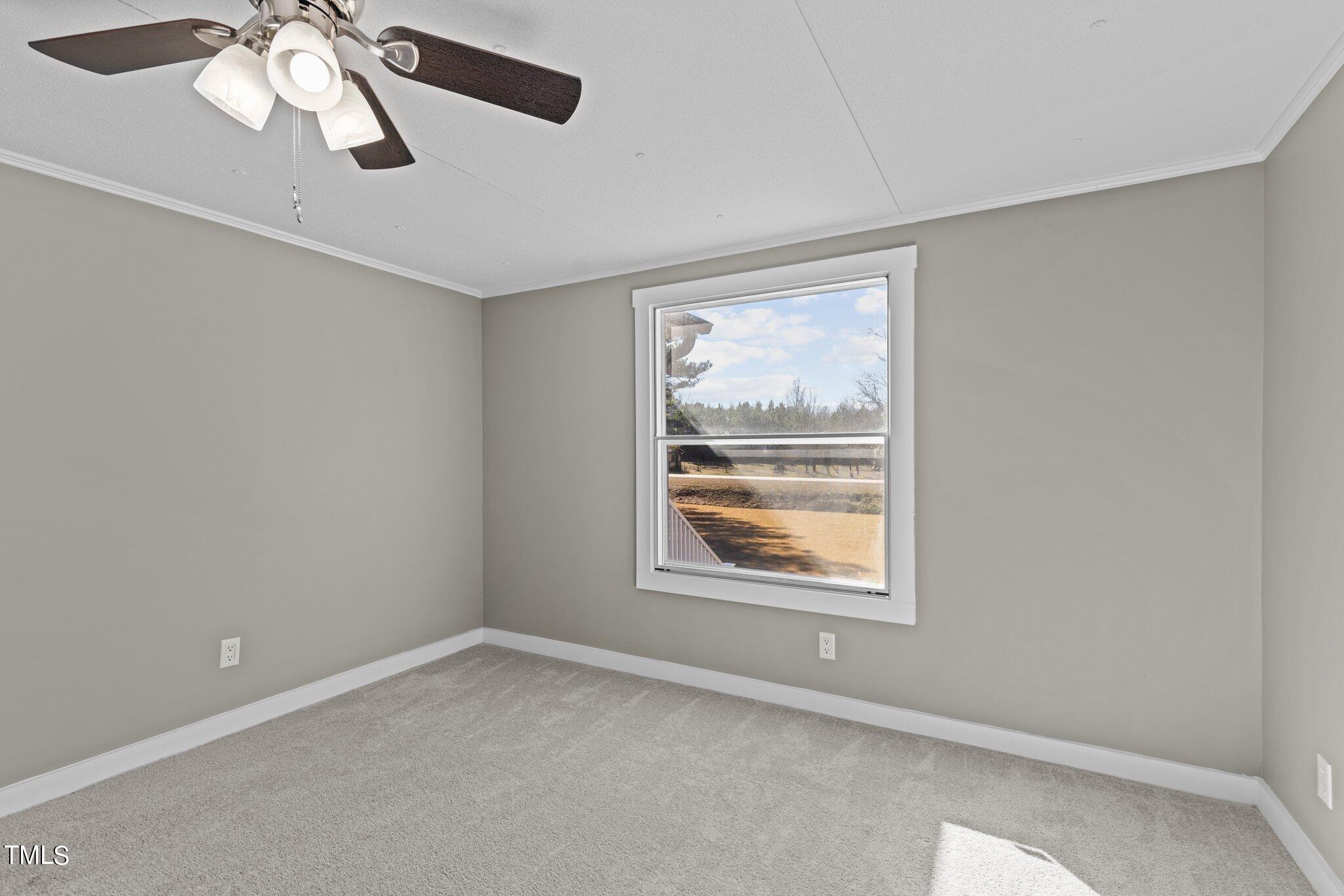 365 Rev Henderson Road Henderson, NC 27537 - Photo 29 of 48 an empty room with a window and a fan