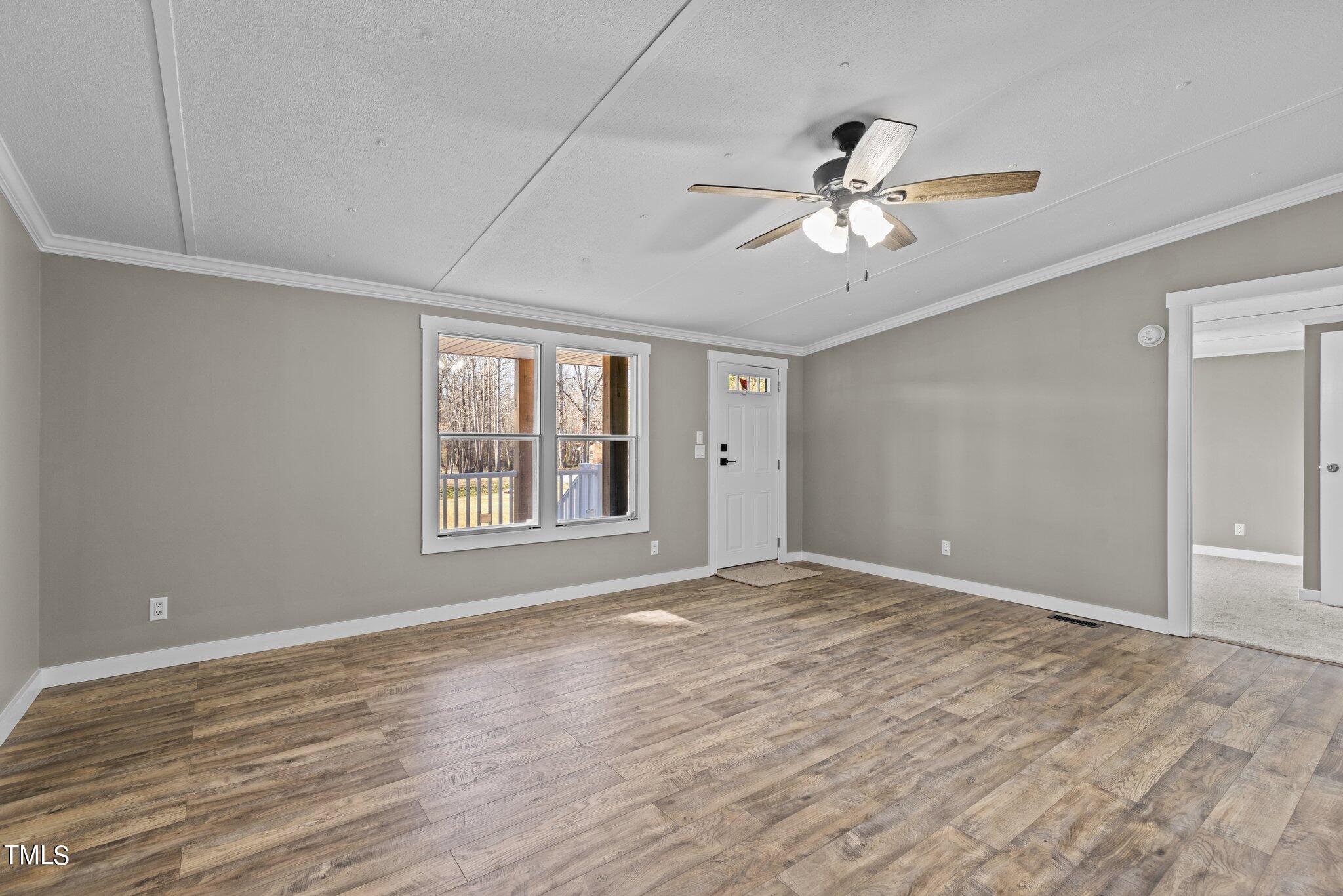 365 Rev Henderson Road Henderson, NC 27537 - Photo 7 of 48 a view of an empty room with a window and a ceiling fan