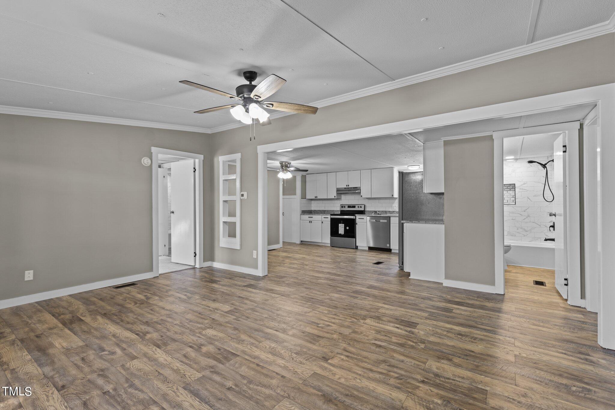 365 Rev Henderson Road Henderson, NC 27537 - Photo 8 of 48 a view of a kitchen with wooden floor and a ceiling fan