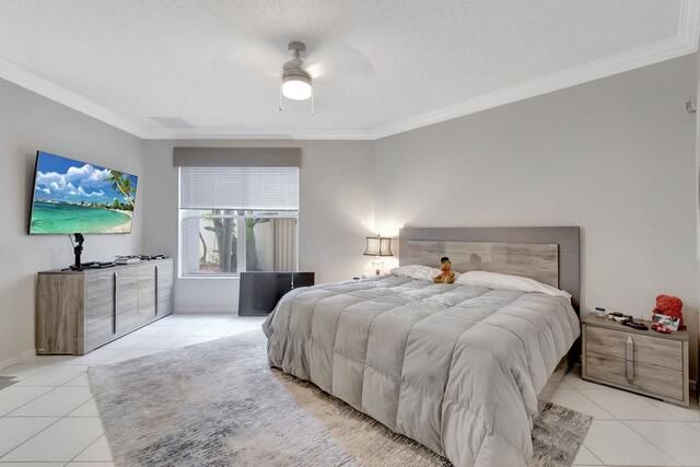 a spacious bedroom with a bed and a flat screen tv