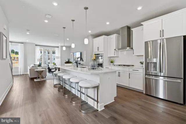 a kitchen with counter top space a sink appliances and cabinets