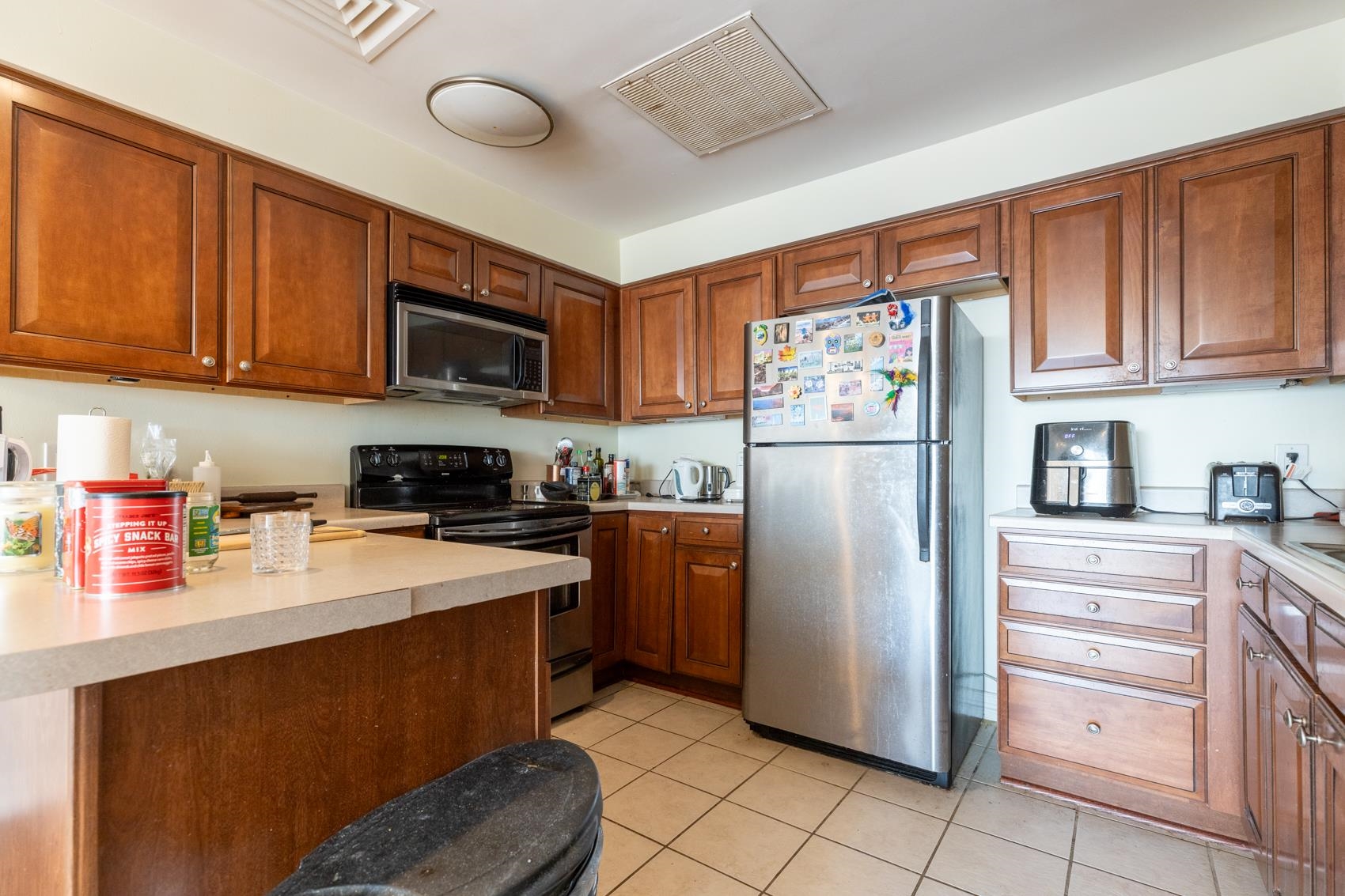 655 Riverside Drive, Unit 1008A Memphis, TN 38103 - Photo 8 of 10 Kitchen with stainless steel appliances, light tile patterned floors, light countertops, and brown cabinets