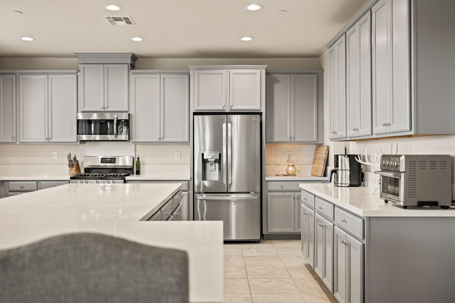 4040 Aura Way Rancho Cordova, CA 95742 - Photo 16 of 49 a kitchen with a refrigerator a microwave and cabinets