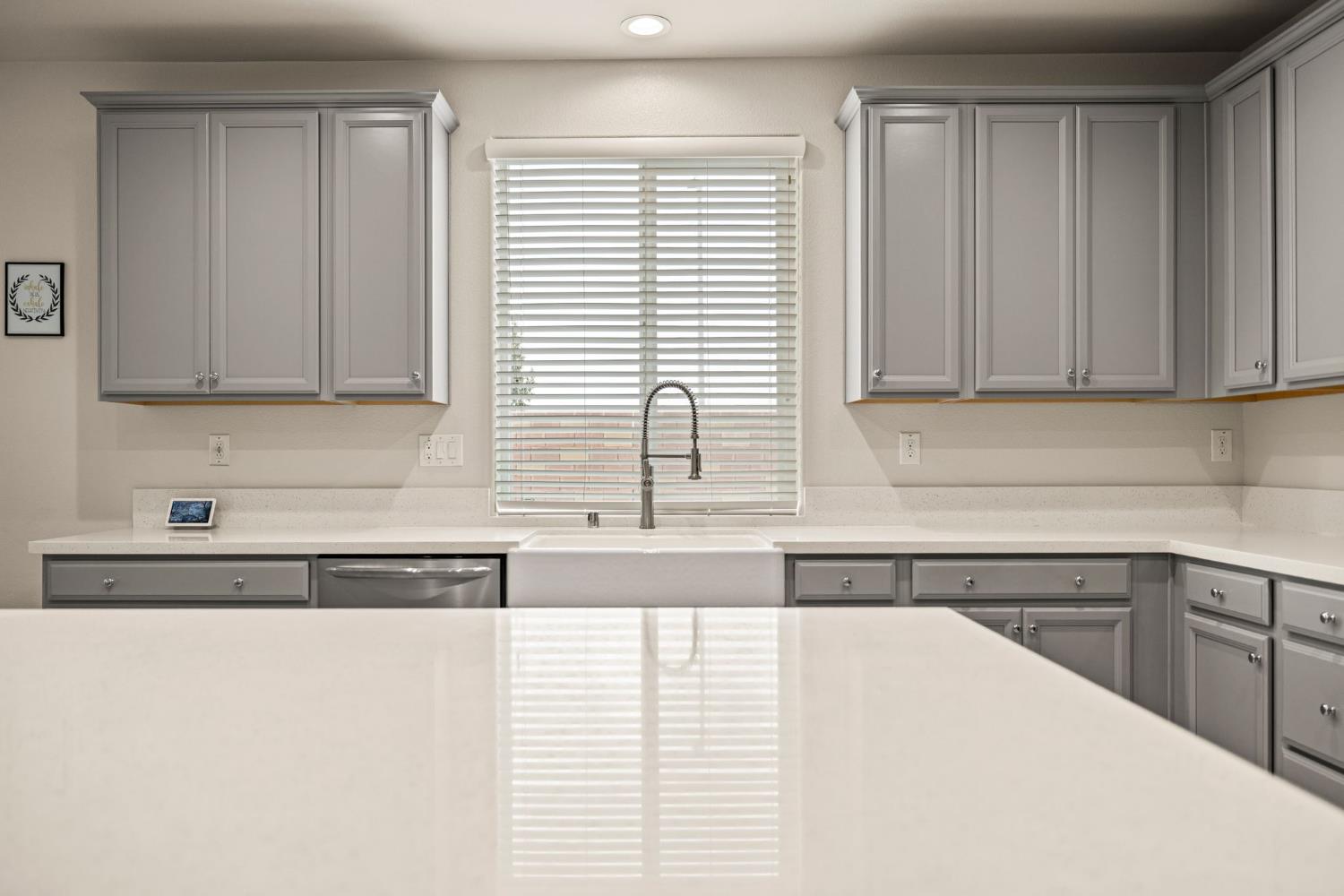 4040 Aura Way Rancho Cordova, CA 95742 - Photo 18 of 49 a kitchen with stainless steel appliances granite countertop white cabinets and a window