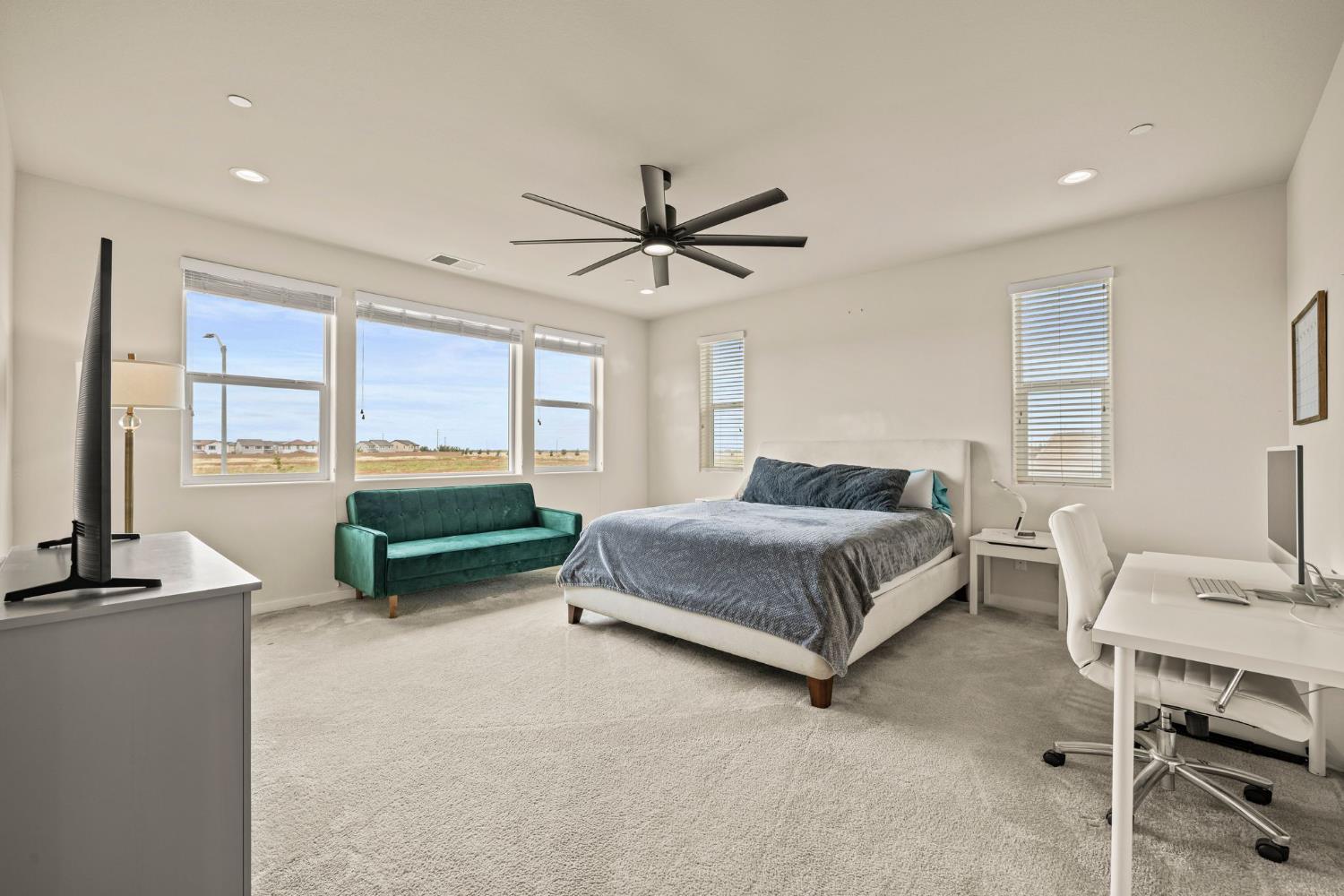 4040 Aura Way Rancho Cordova, CA 95742 - Photo 23 of 49 a bedroom with a bed and a chandelier