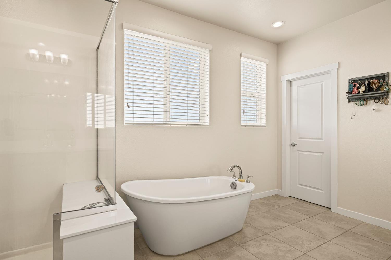 4040 Aura Way Rancho Cordova, CA 95742 - Photo 30 of 49 a bathroom with a bathtub and a window